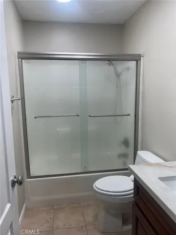 a bathroom with a toilet a sink and shower