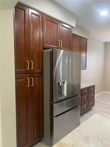 a metallic refrigerator freezer sitting in a kitchen