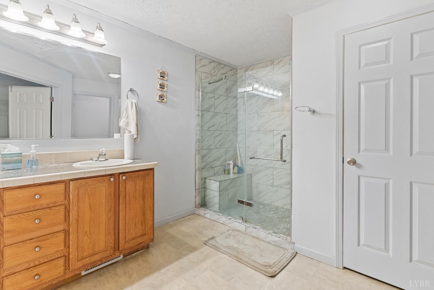 1720 Gallows Road Gretna, VA 24557 - Photo 20 of 73 a bathroom with a granite countertop sink a mirror and a shower