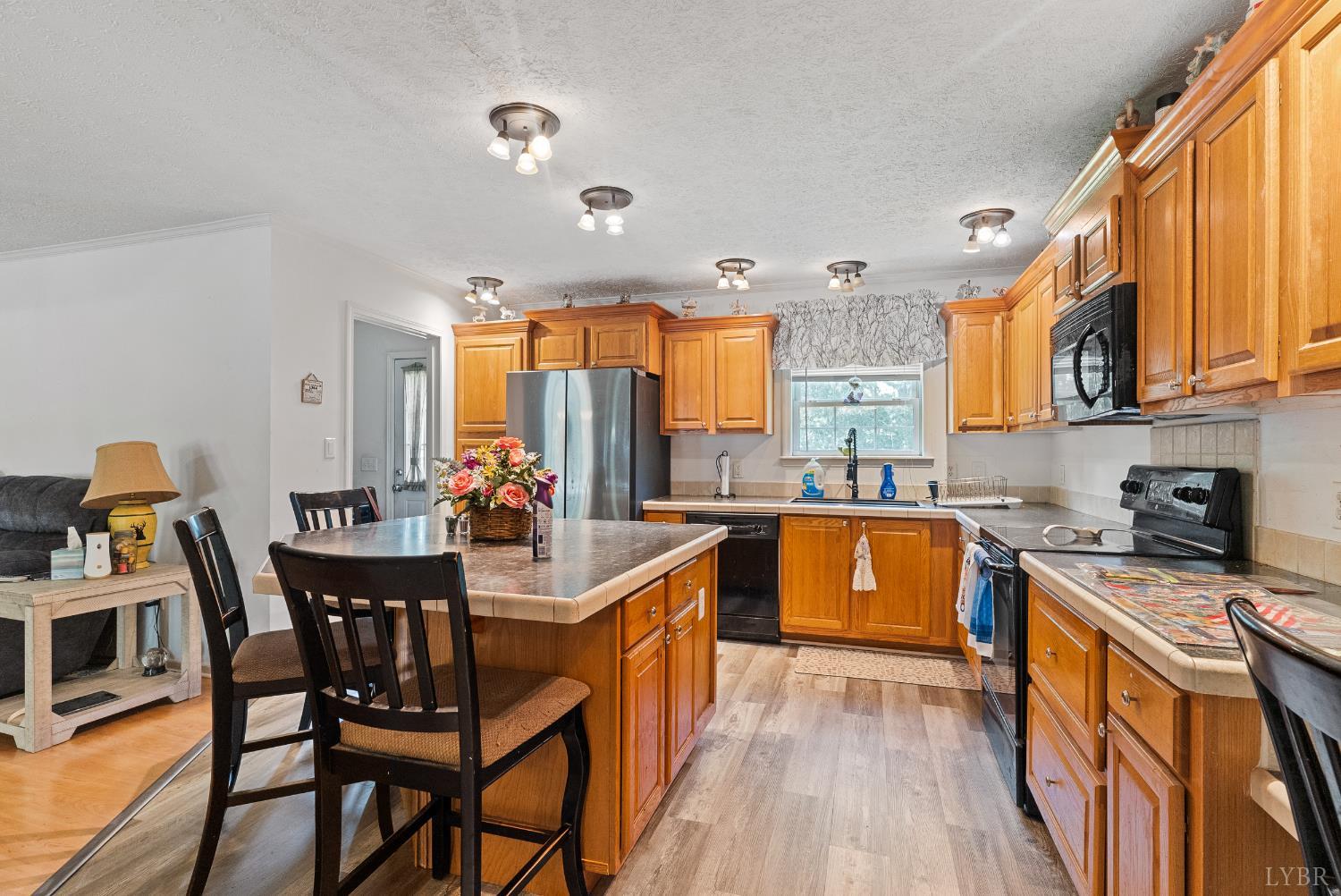1720 Gallows Road Gretna, VA 24557 - Photo 10 of 73 a kitchen with stainless steel appliances granite countertop a stove a sink dishwasher and a refrigerator with wooden floor