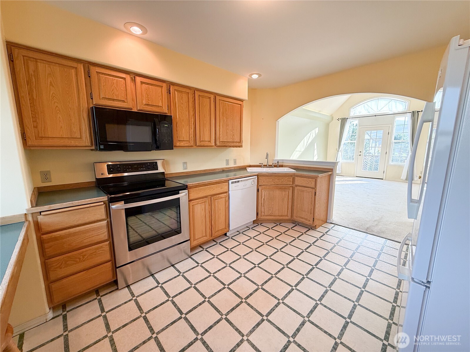 334 Omak River Road Omak, WA 98841 - Photo 11 of 31 a kitchen with a sink cabinets and stainless steel appliances