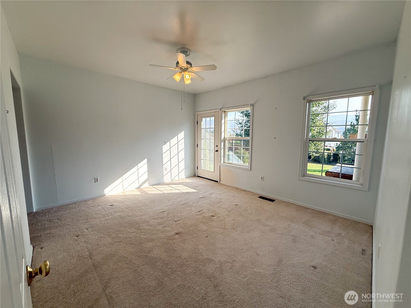 334 Omak River Road Omak, WA 98841 - Photo 17 of 31 an empty room with windows and chandelier fan