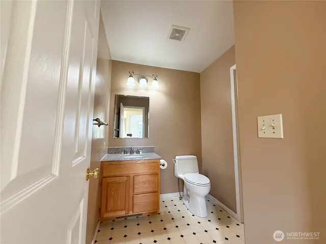 a bathroom with a toilet a sink and a mirror