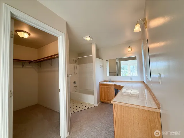 a bathroom with a tub and mirror