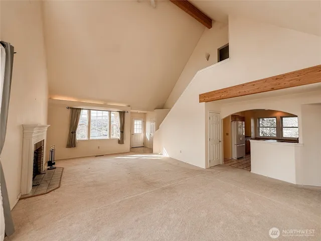a view of a livingroom with a fireplace and window