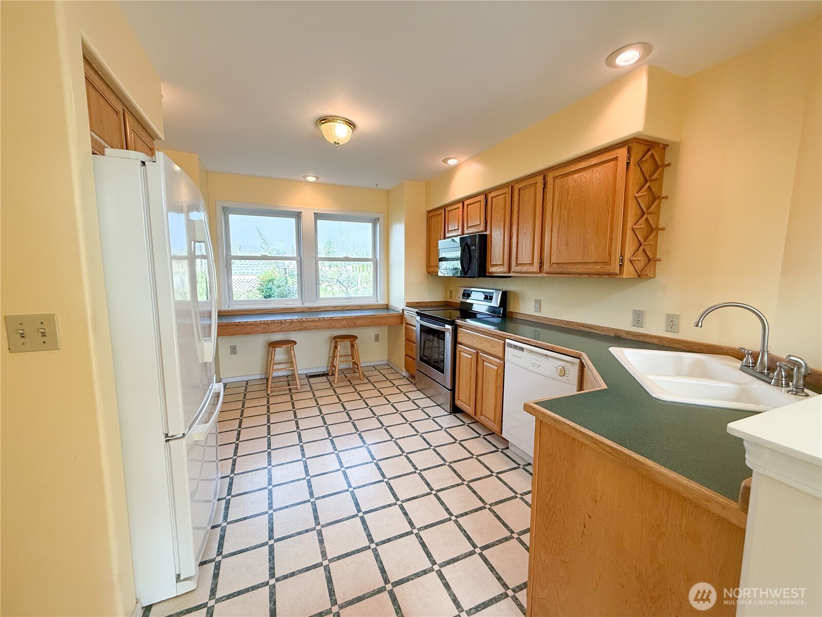 334 Omak River Road Omak, WA 98841 - Photo 10 of 31 a kitchen with stainless steel appliances granite countertop a sink stove and refrigerator