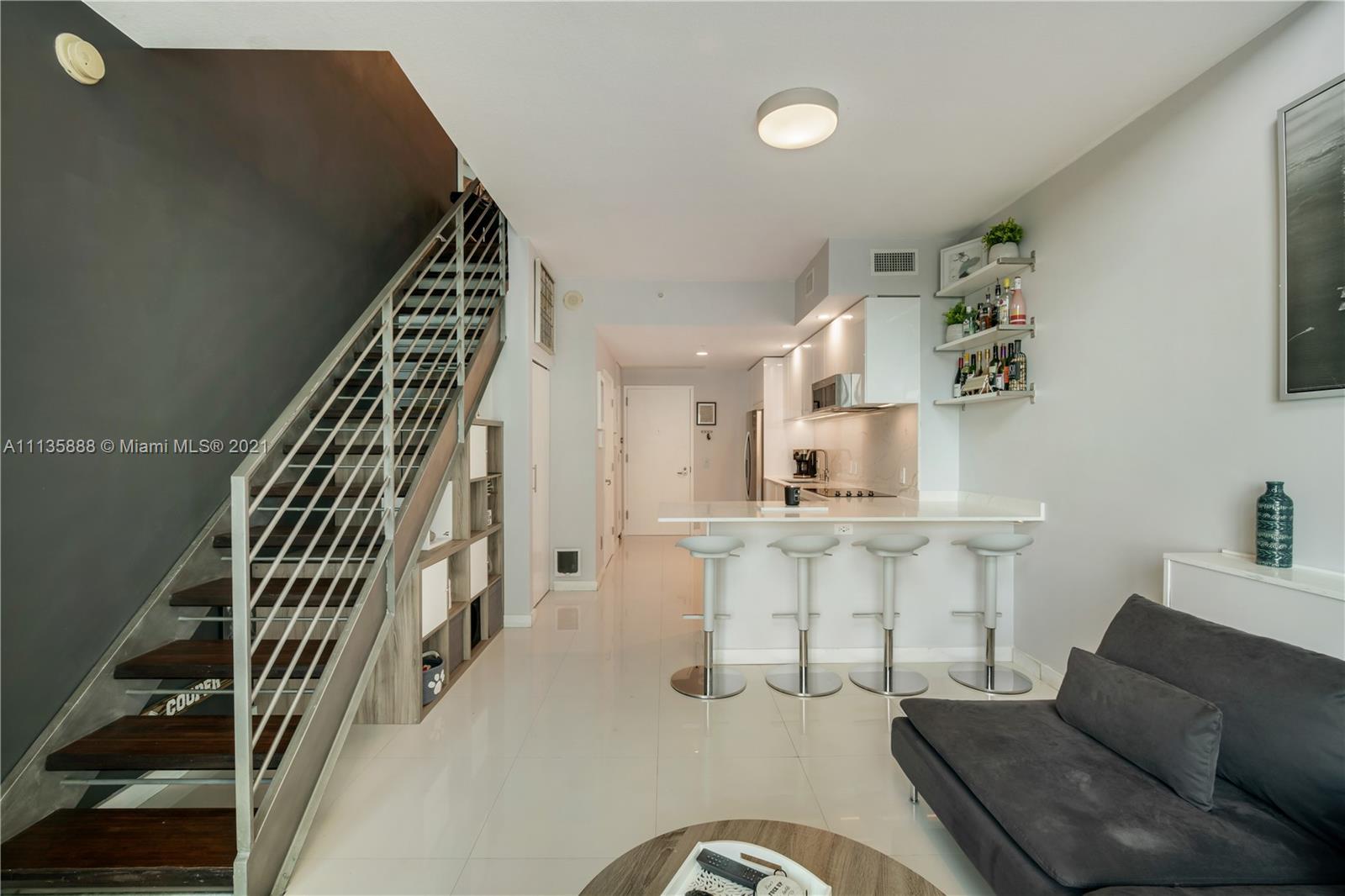 60 Southwest 13th Street, Unit 2204 Miami, FL 33130 - Photo 13 of 25 a living room with furniture and stairs