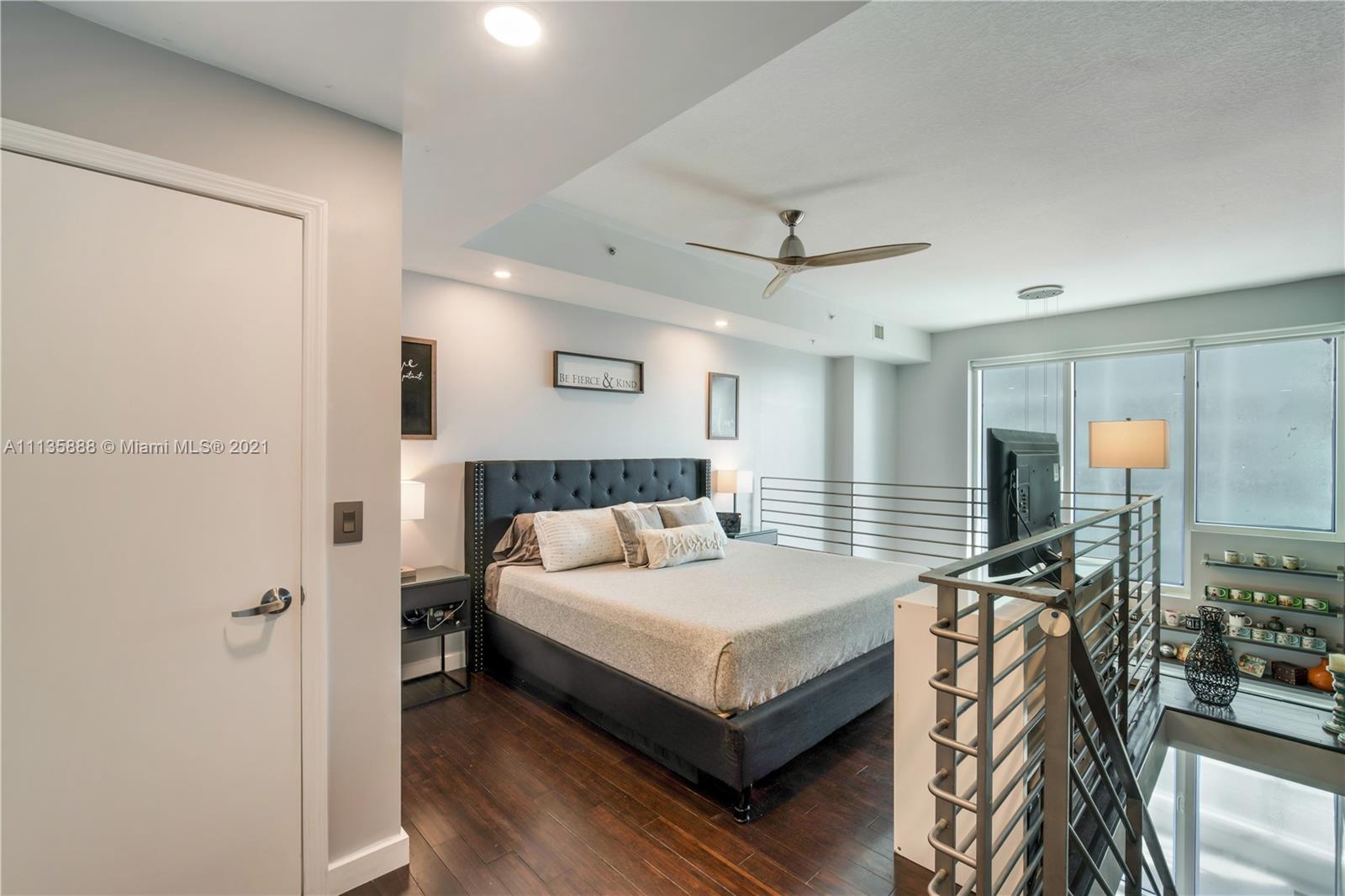 60 Southwest 13th Street, Unit 2204 Miami, FL 33130 - Photo 14 of 25 a bedroom with a bed and a table in it