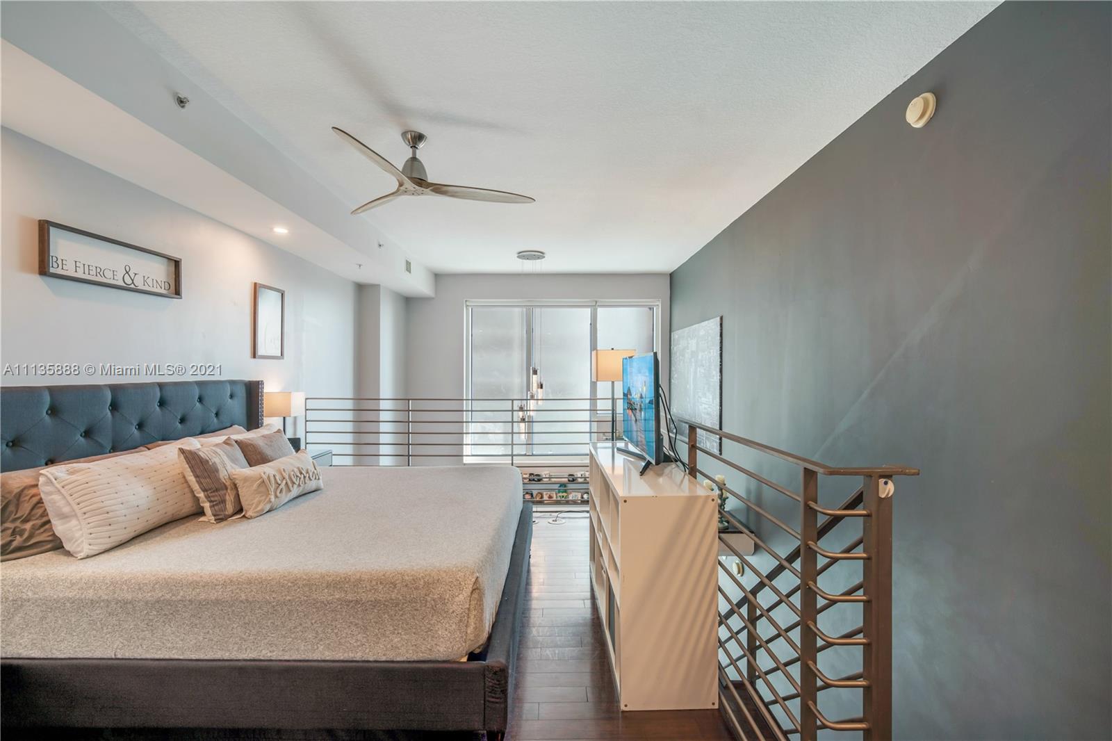 60 Southwest 13th Street, Unit 2204 Miami, FL 33130 - Photo 15 of 25 a bedroom with a bed and window