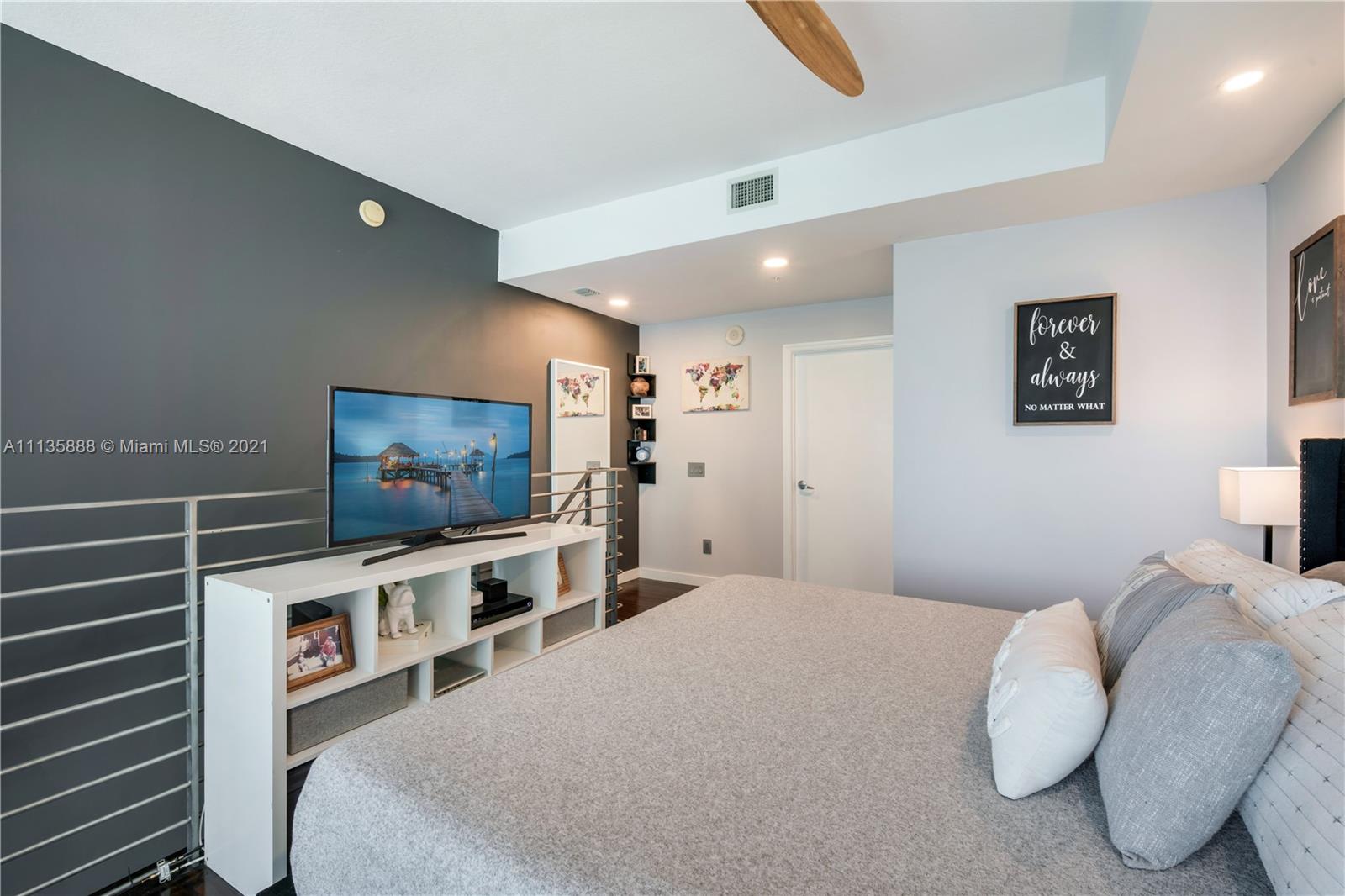 60 Southwest 13th Street, Unit 2204 Miami, FL 33130 - Photo 17 of 25 a bedroom with furniture and a flat screen tv