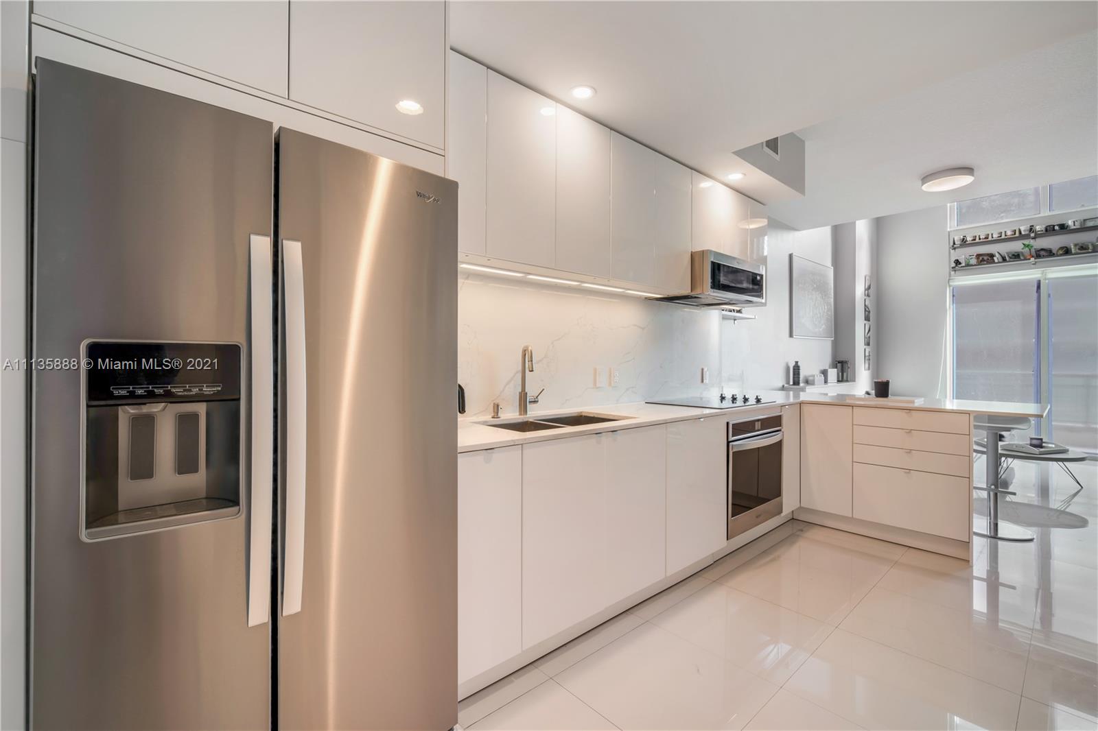 60 Southwest 13th Street, Unit 2204 Miami, FL 33130 - Photo 3 of 25 a kitchen with a refrigerator sink and stove