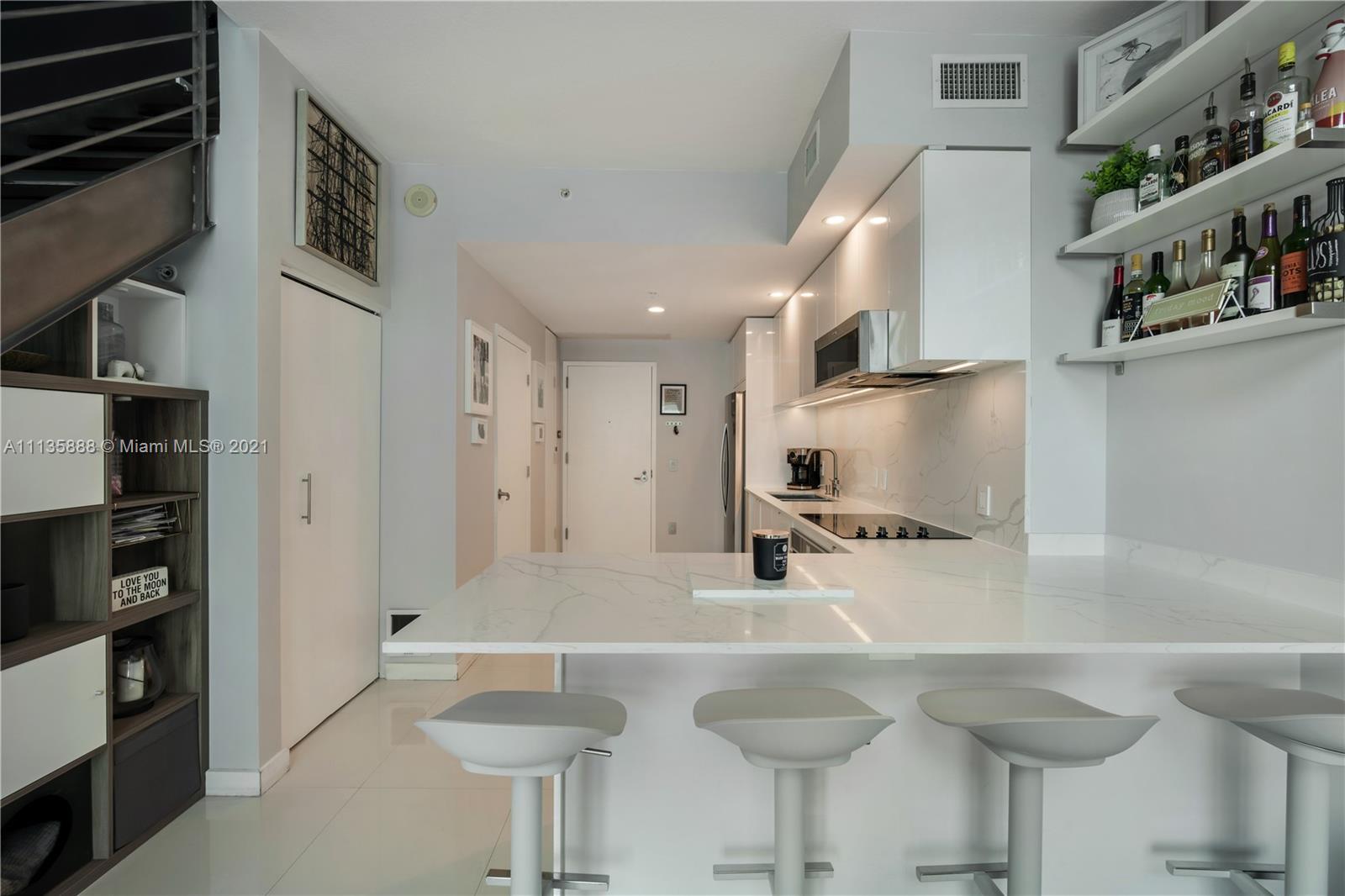 60 Southwest 13th Street, Unit 2204 Miami, FL 33130 - Photo 7 of 25 a kitchen with stainless steel appliances granite countertop a sink and a refrigerator