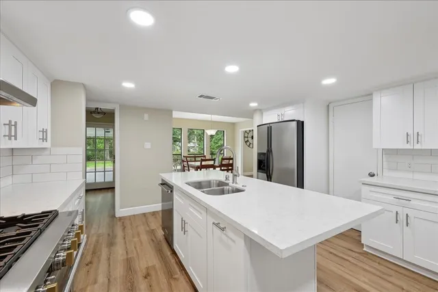 a kitchen with a sink stove and refrigerator