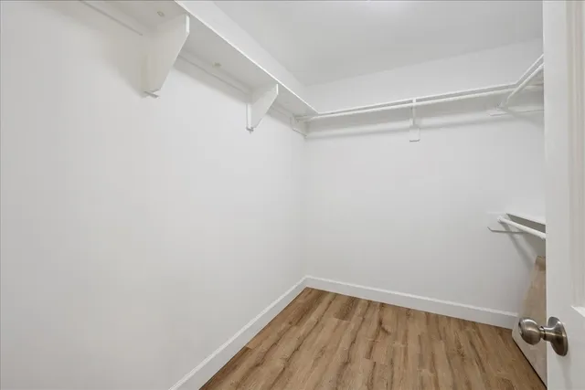 a view of a room with wooden floor