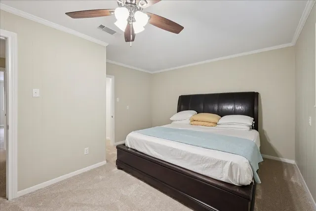 a bedroom with a bed and ceiling fan