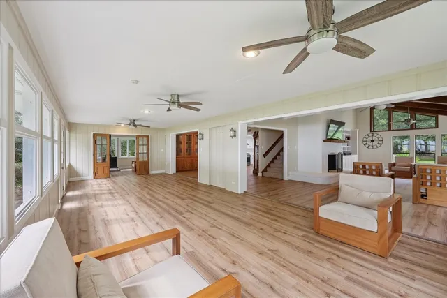 a view of living room filled with furniture and wooden floor