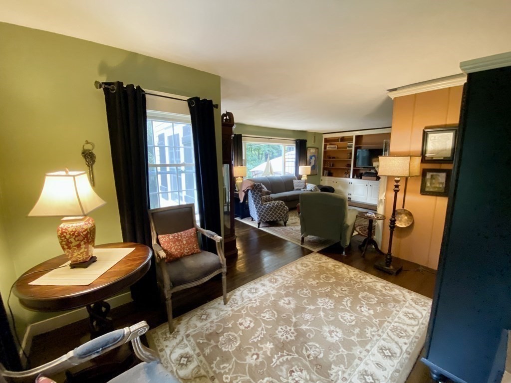 7 McGregory Road Sturbridge, MA 01566 - Photo 16 of 40 a living room with furniture and a lamp