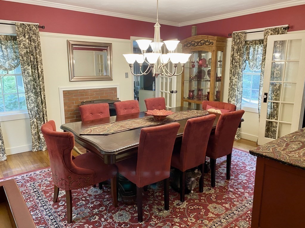 7 McGregory Road Sturbridge, MA 01566 - Photo 19 of 40 a dining room with furniture a chandelier and window