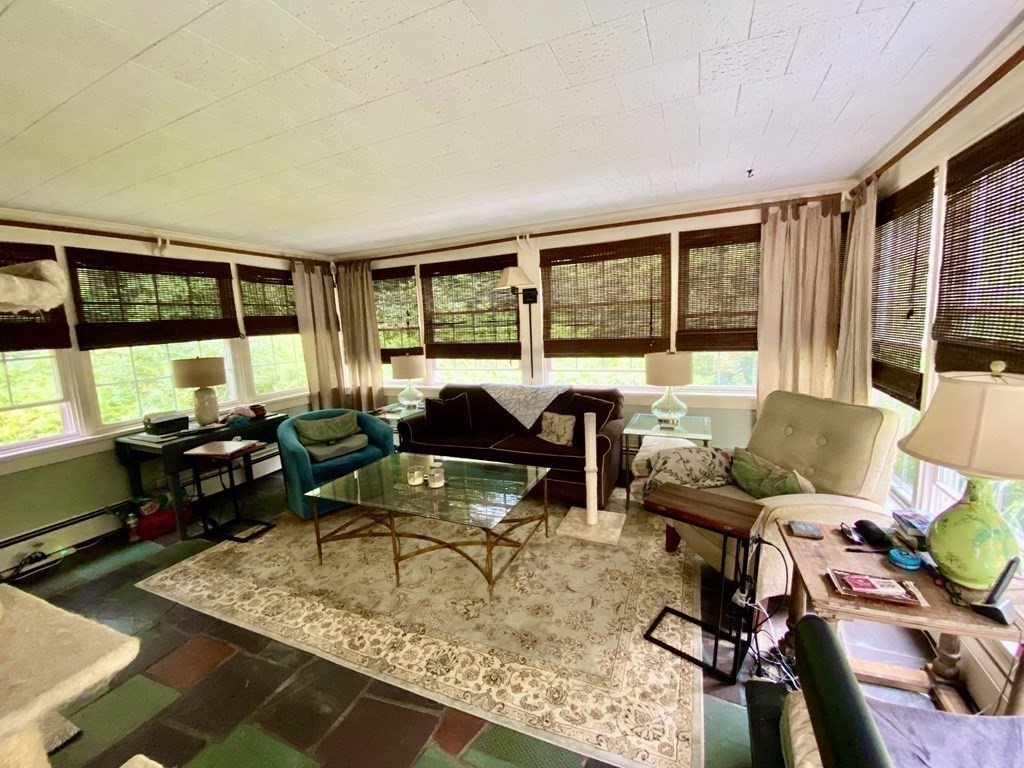 7 McGregory Road Sturbridge, MA 01566 - Photo 20 of 40 a living room with furniture and floor to ceiling windows