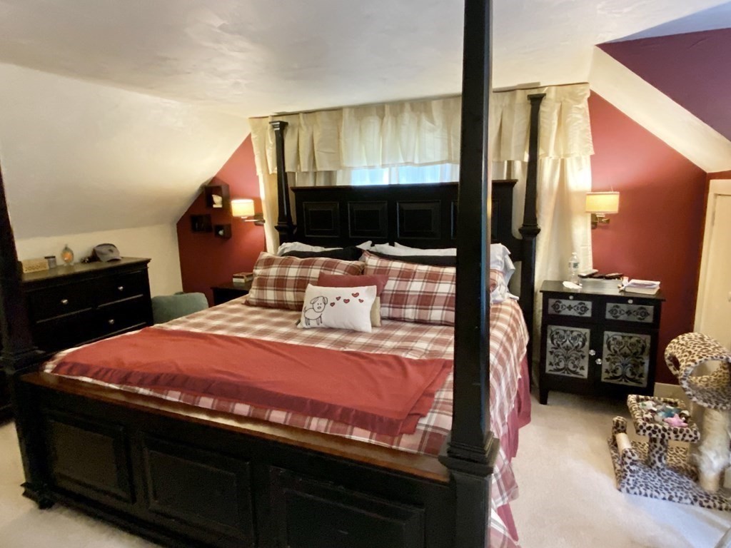 7 McGregory Road Sturbridge, MA 01566 - Photo 28 of 40 a bedroom with a bed and a flat tv screen on dresser