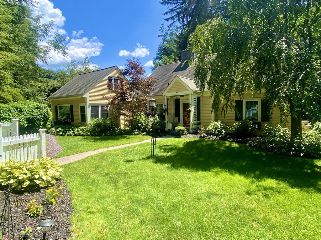 7 McGregory Road Sturbridge, MA 01566 - Photo 4 of 40 a front view of a house with swimming pool and garden