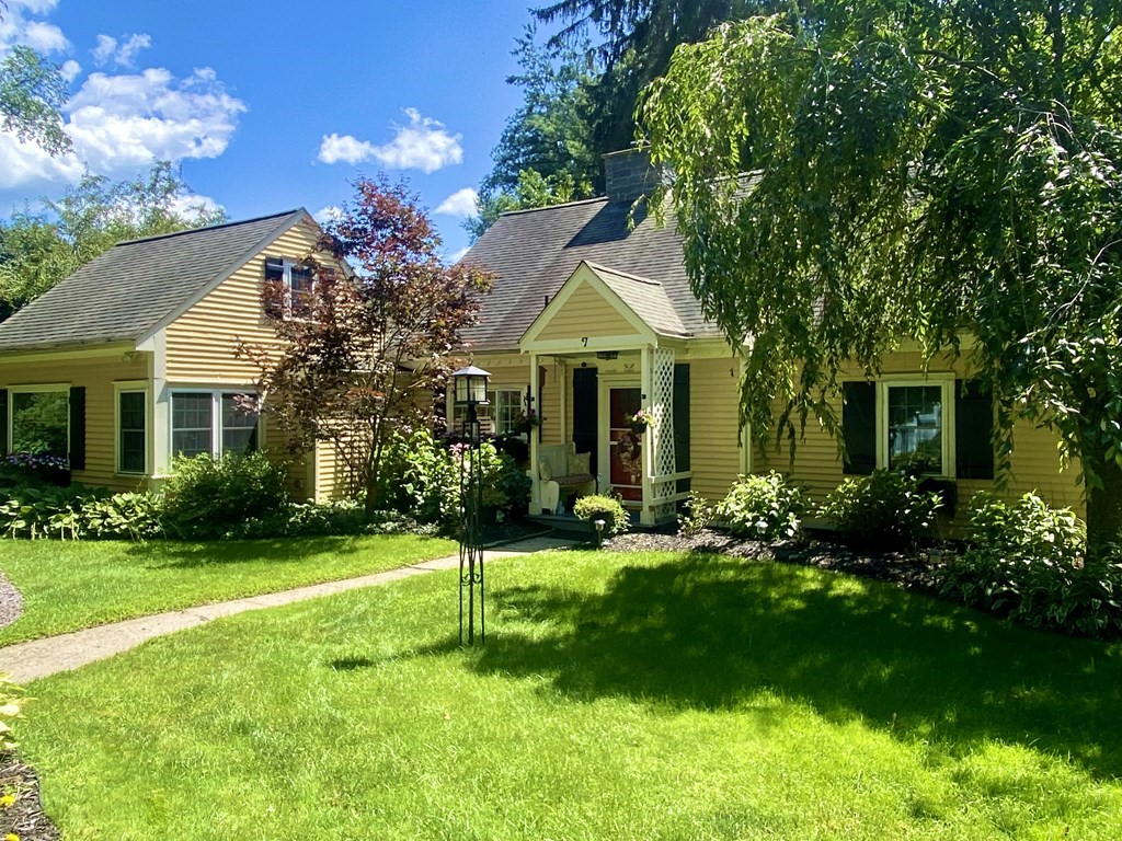 7 McGregory Road Sturbridge, MA 01566 - Photo 5 of 40 a front view of a house with a yard table and chairs