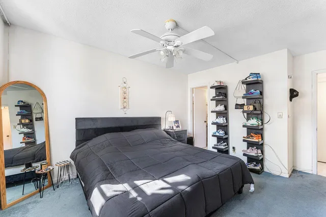 a bedroom with a large bed and a chandelier