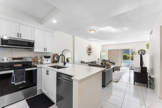a kitchen with a sink stove and cabinets