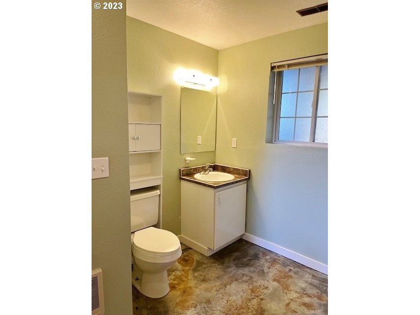 3331 Southwest Kirk Avenue Pendleton, OR 97801 - Photo 13 of 25 a bathroom with a granite countertop toilet and a sink