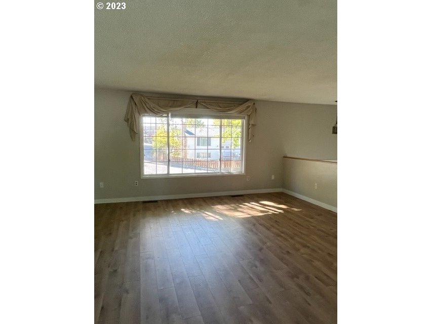 3331 Southwest Kirk Avenue Pendleton, OR 97801 - Photo 3 of 25 a view of empty room with wooden floor and fan