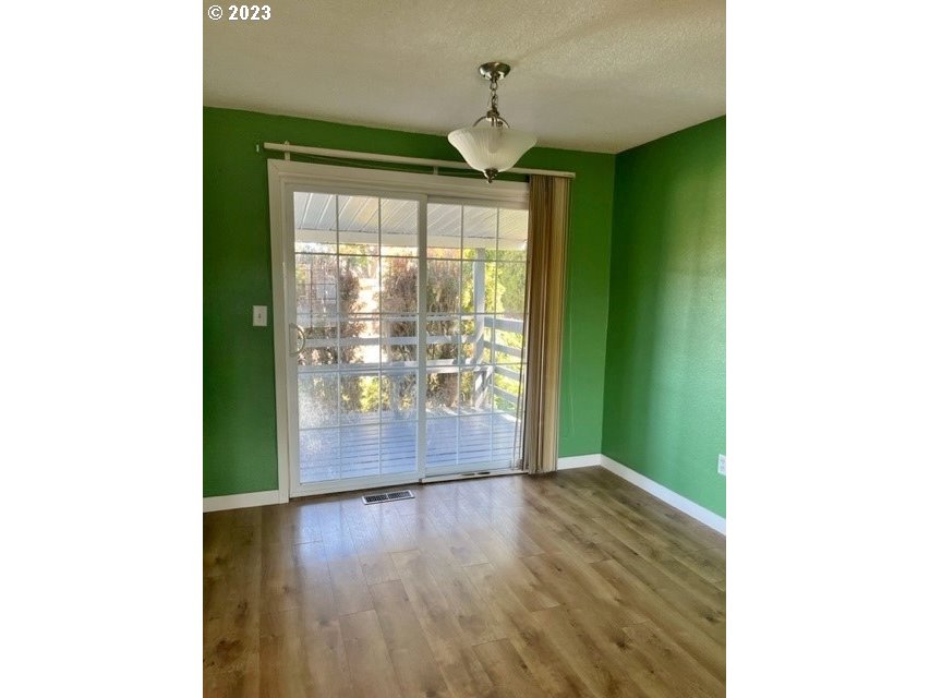 3331 Southwest Kirk Avenue Pendleton, OR 97801 - Photo 6 of 25 a view of an empty room with wooden floor and a window