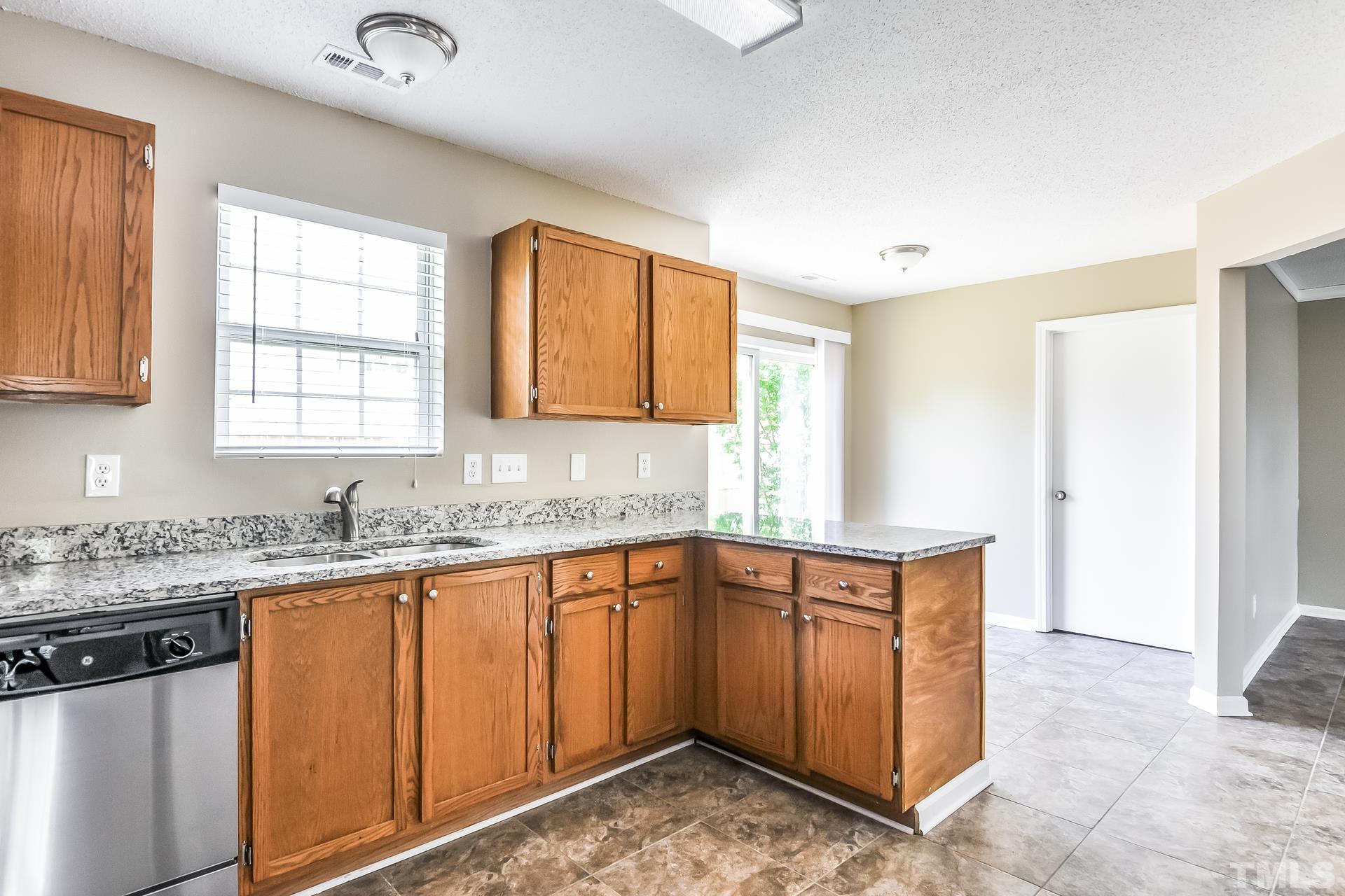 313 Pebble Way Durham, NC 27703 - Photo 8 of 17 a kitchen that has a sink and a stove in it