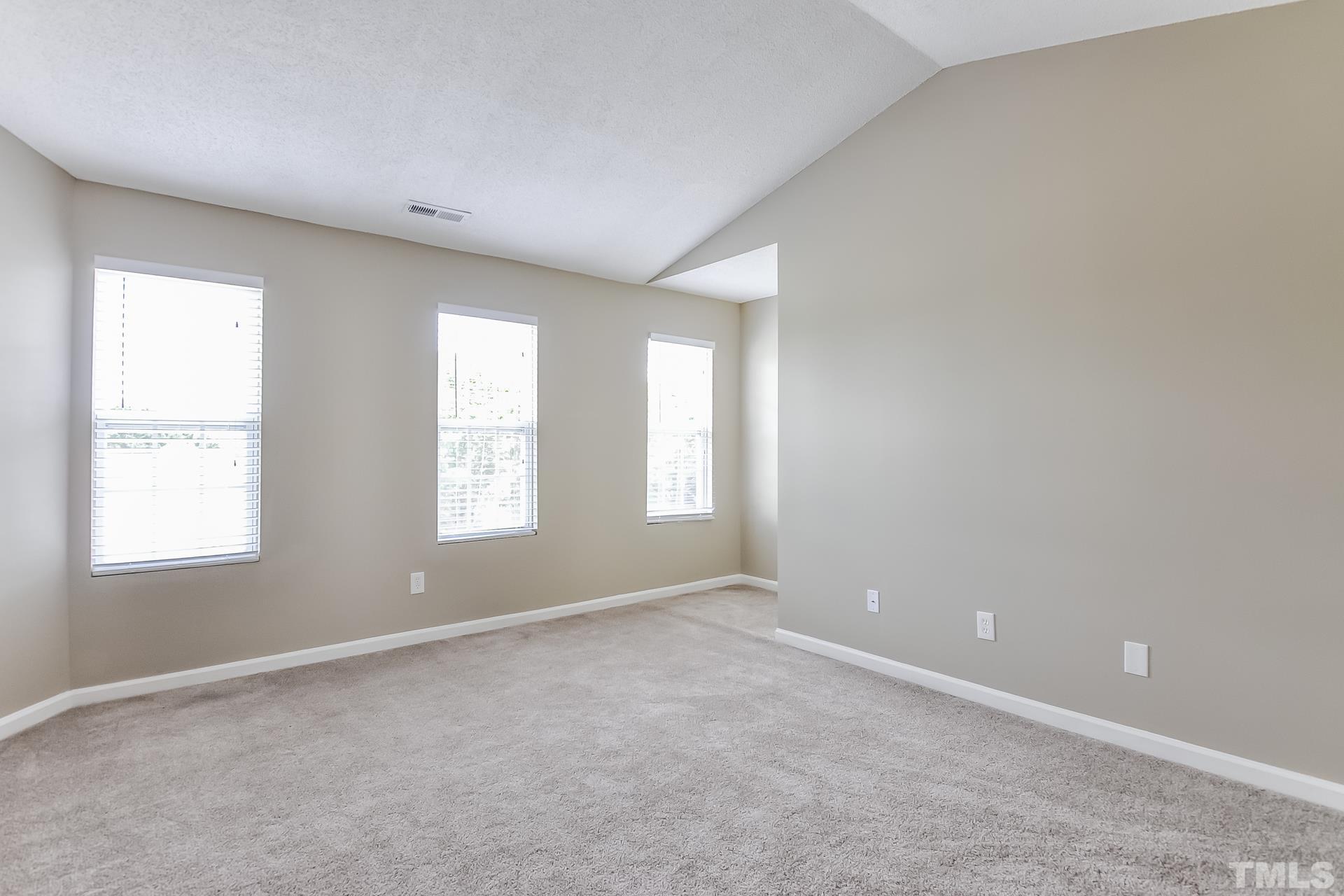 313 Pebble Way Durham, NC 27703 - Photo 9 of 17 an empty room with windows