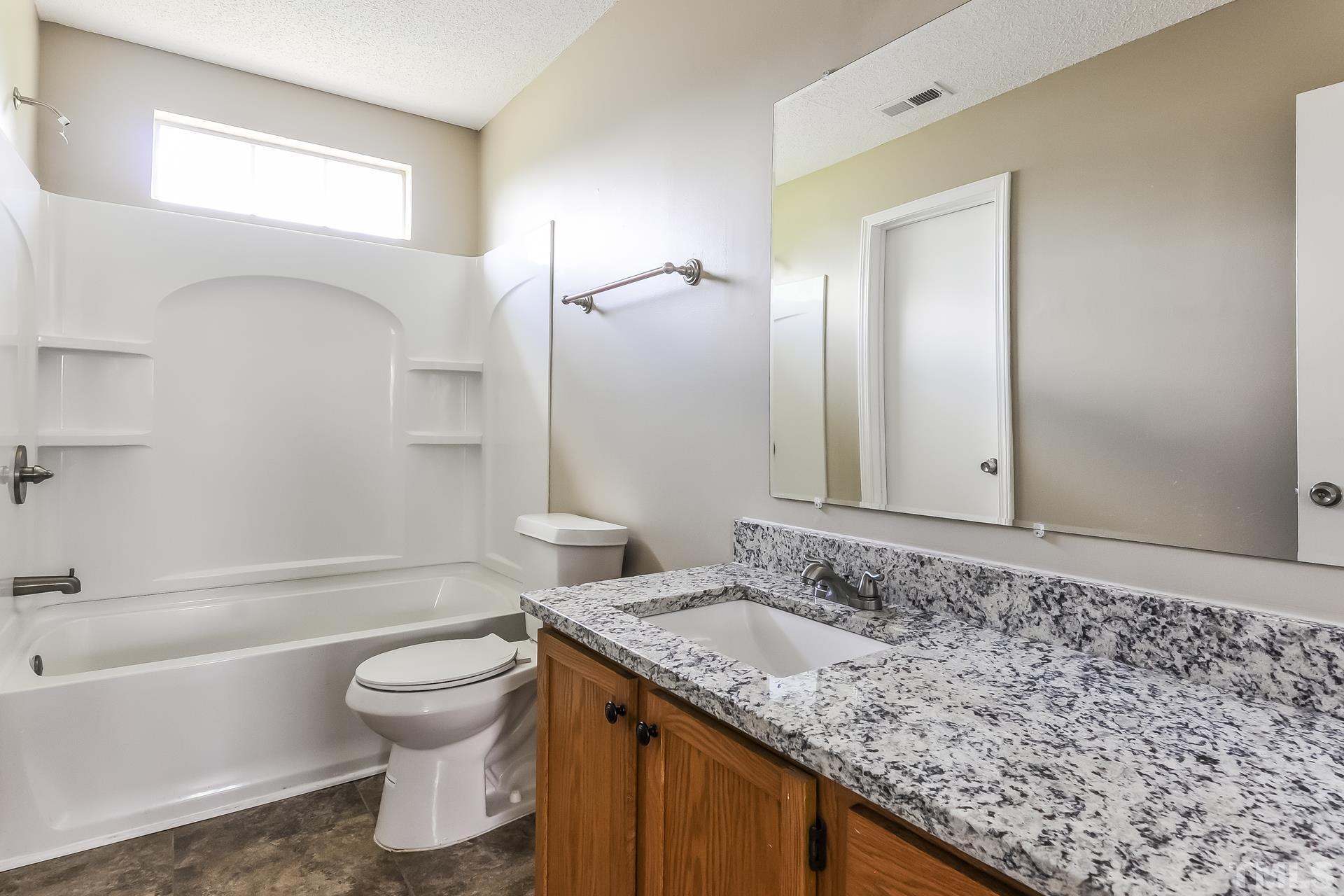 313 Pebble Way Durham, NC 27703 - Photo 10 of 17 a bathroom with a granite countertop sink toilet and shower