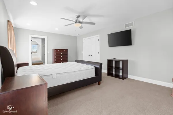 a bedroom with a bed and a flat screen tv
