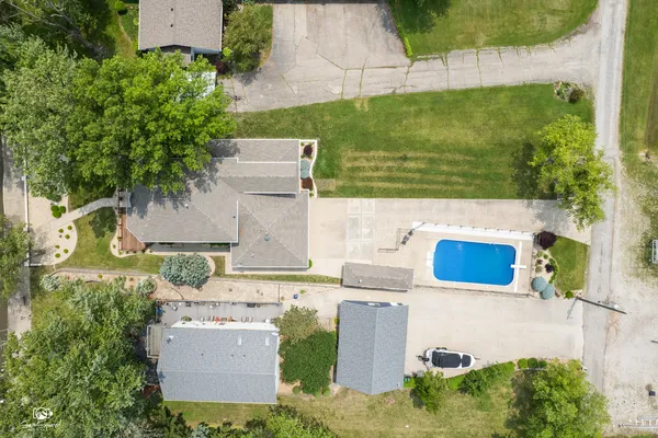 an aerial view of a house with a yard