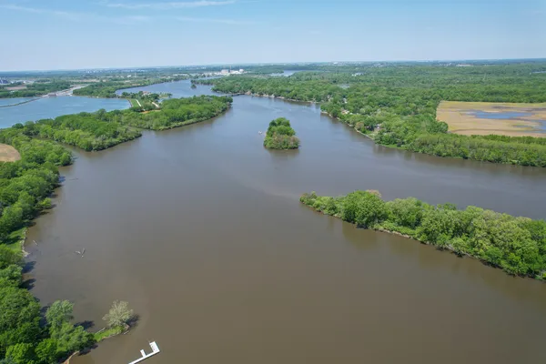 an aerial view of lake and residential houses with outdoor space