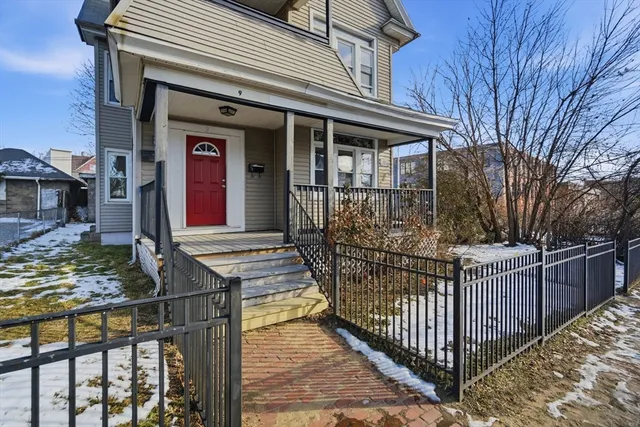 a front view of a house with wooden fence