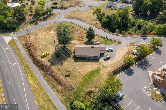 an aerial view of a house with a yard