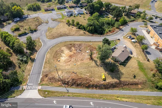 an aerial view of a residential houses with yard