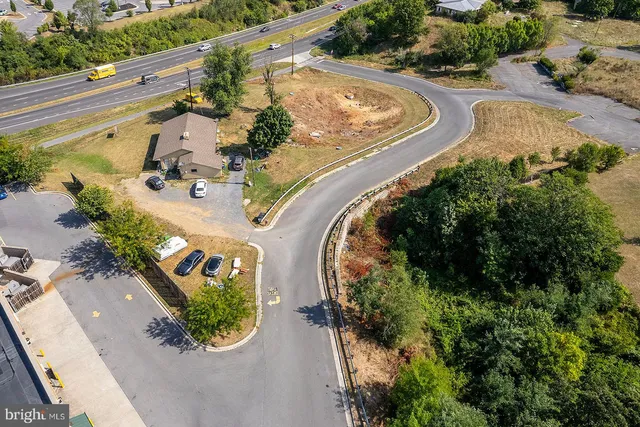 an aerial view of a swimming pool with a yard