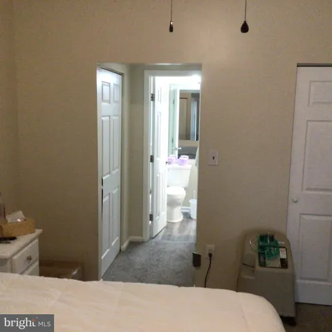 a bedroom with a bed and hallway