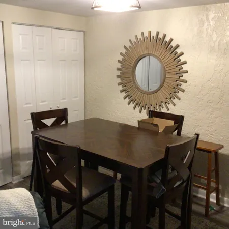 a view of a dining room with a table and chairs