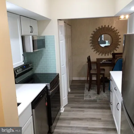 a kitchen with a sink and a stove top oven