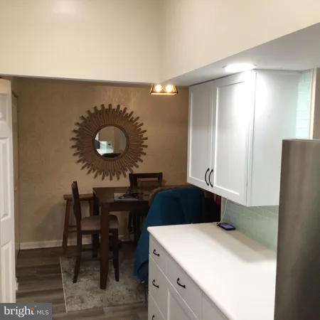 a kitchen with a table and chairs in it