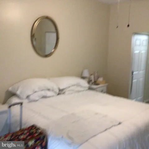 a bedroom with a bed and a mirror