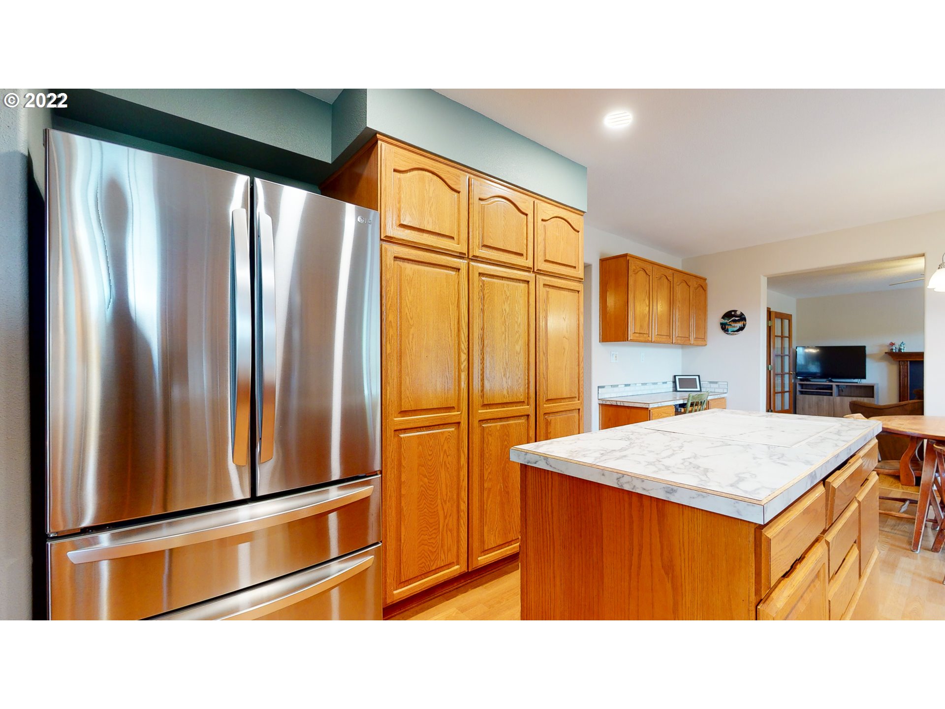 32902 Baxter Road Hermiston, OR 97838 - Photo 13 of 30 a room with stainless steel appliances kitchen island granite countertop a refrigerator and microwave