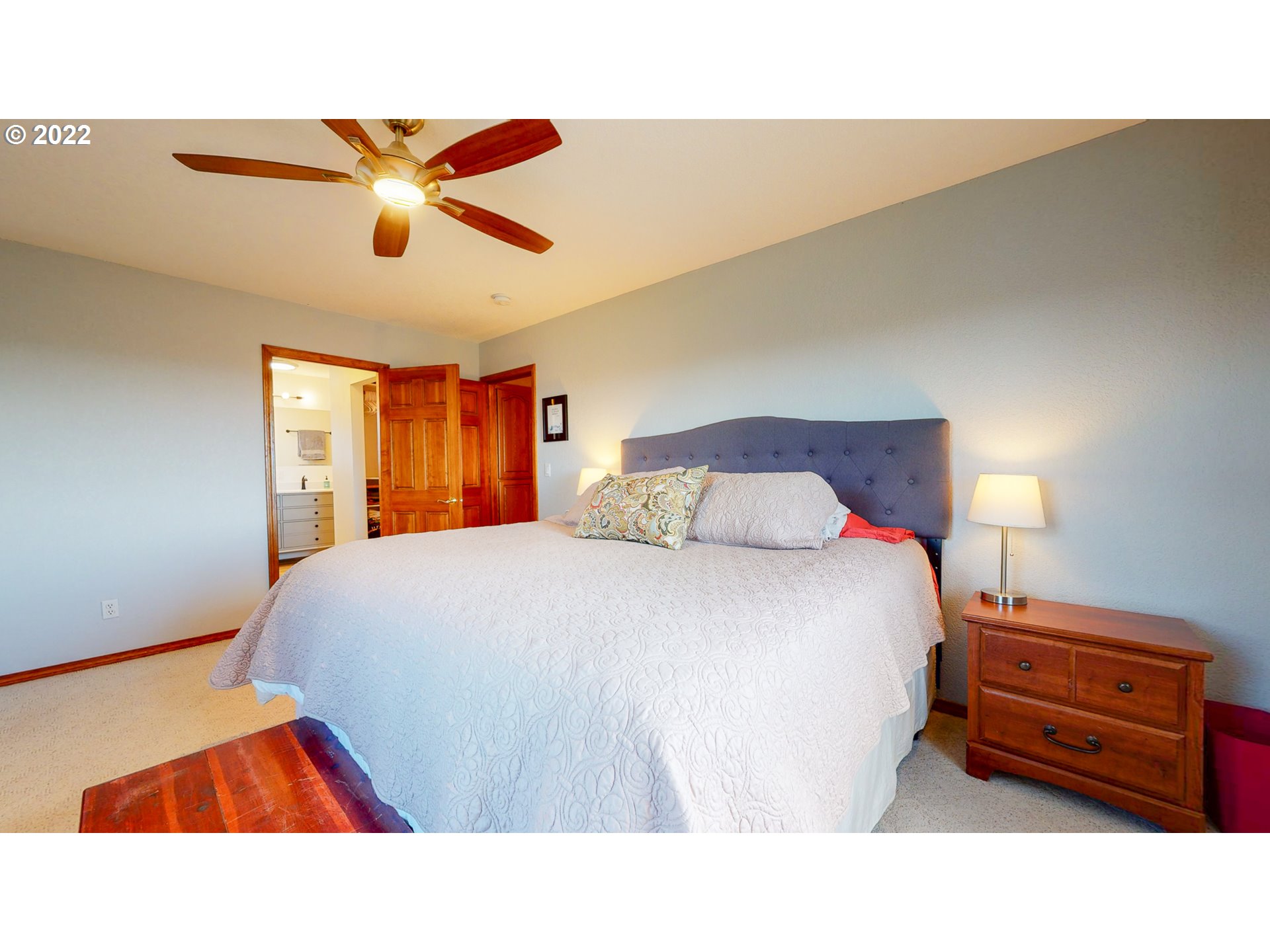 32902 Baxter Road Hermiston, OR 97838 - Photo 20 of 30 a bedroom with a bed and a chandelier