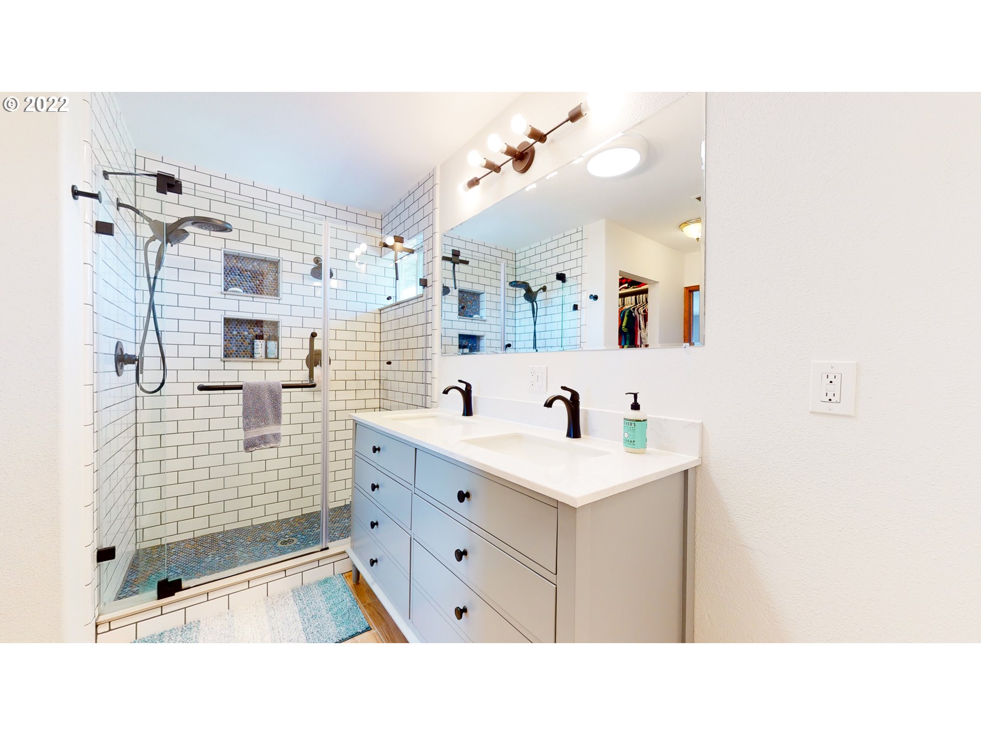 32902 Baxter Road Hermiston, OR 97838 - Photo 21 of 30 a bathroom with a sink a toilet a mirror and shower