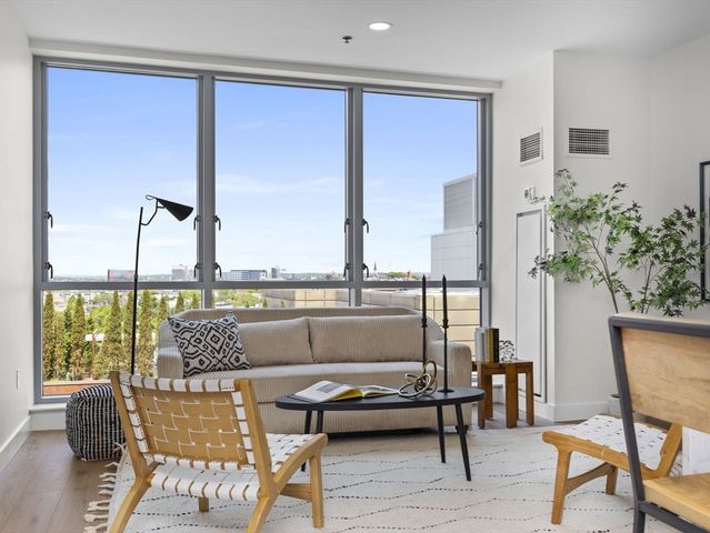 a living room with a large window and a table